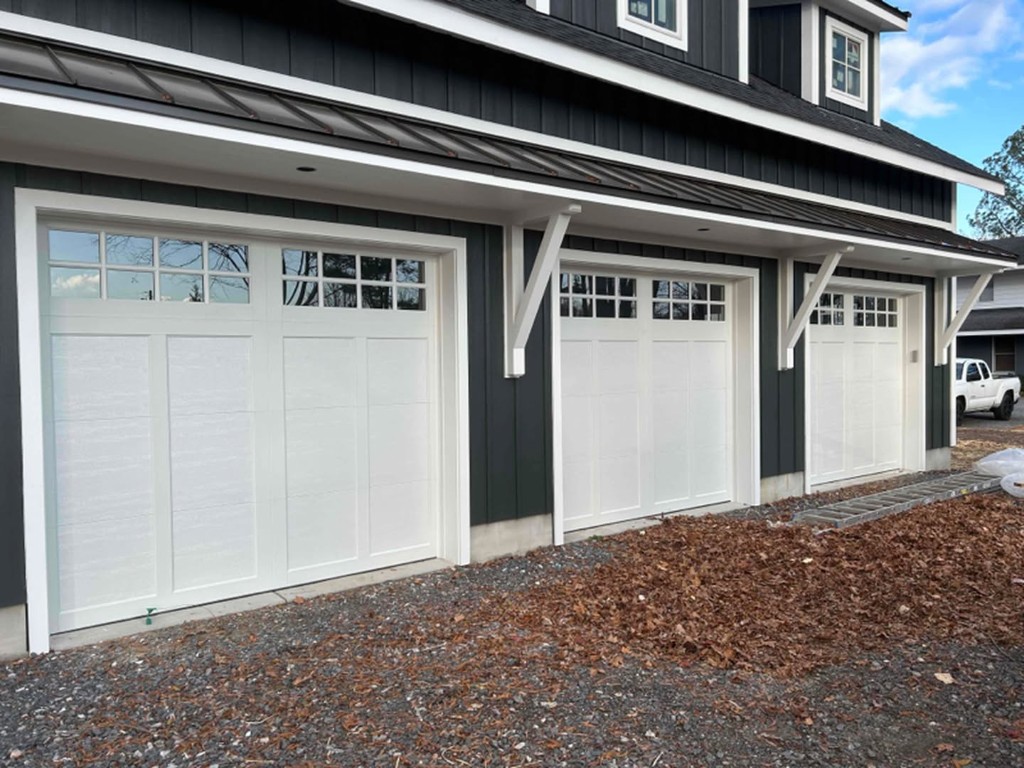 White garage doors on a dark gray home